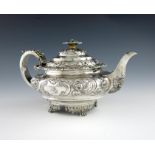 λ A George IV silver teapot, by Thomas Death, London 1825, circular bellied form, embossed foliate