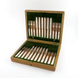 A set of twelve silver fruit knives and forks, by Asprey and Co, Sheffield 1910, plain blades,