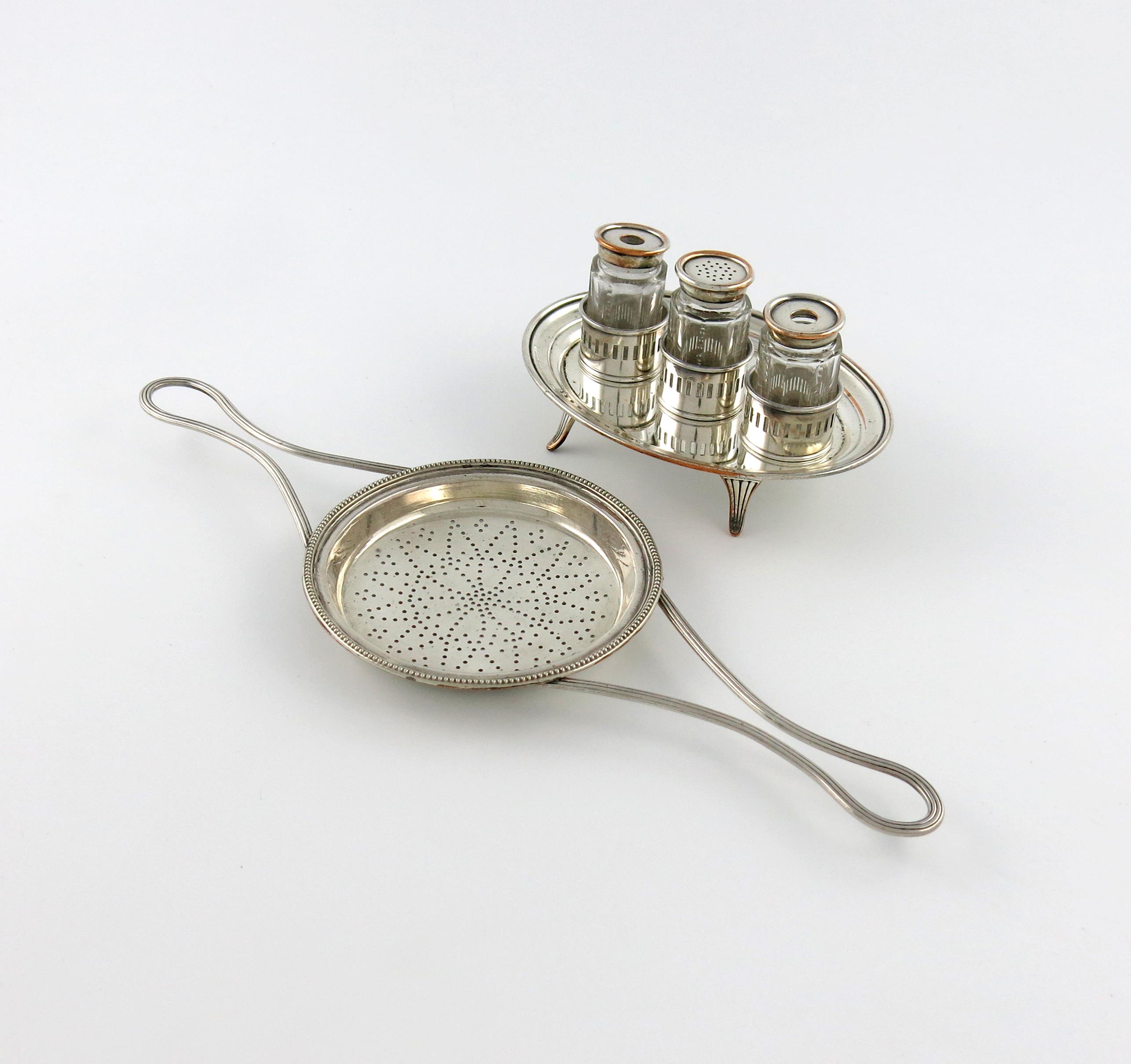 A George III old Sheffield plated two-handled lemon strainer, circa 1780-90, the shallow circular
