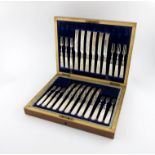 An Edwardian set of twelve silver fruit knives and forks, by J. Round, Sheffield 1903, the blades