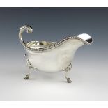 A silver sauce boat, by Carrington and Co, London 1911, oval form, gadroon border, leaf capped