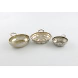 A collection of three French silver wine tasters, comprising: one of plain circular form, snake ring