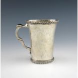 A 19th century silver South American mug, unmarked, tapering circular form, with a scroll handle and