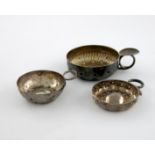 A small collection of three French silver wine tasters, comprising: a small early 19th century