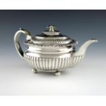 λ A George III silver teapot, by Solomon Hougham, London 1816, circular bellied form, part-fluted