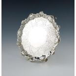 A George III silver waiter, by John Carter, London 1769, circular form, shell and scroll border, the