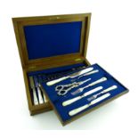 A set of eighteen Victorian silver fruit knives and forks with a serving knife and fork and a pair