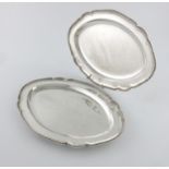 A pair of George III silver meat platters, by James Young, London 1787, shaped oval form, beaded