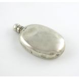 A Victorian silver hip flask, by George Adams, London 1878, plain oval form, screw-off cover with