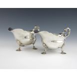 A pair of Edwardian silver sauce boats, by Butt and Co, London 1909, oval form, wavy-edge border,