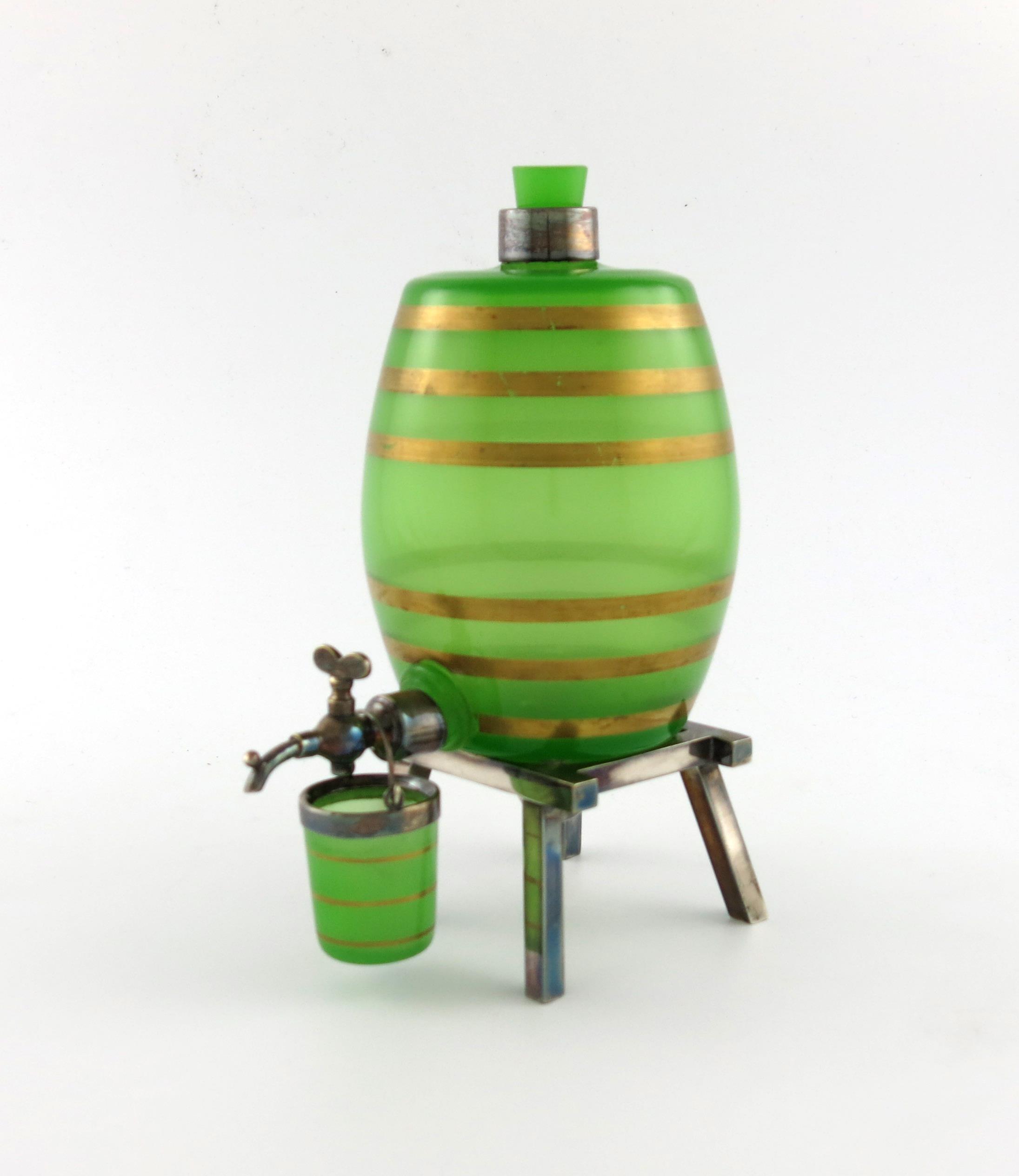 By Asprey and Co, and electroplated mounted green glass spirit barrel, the upright barrel with a