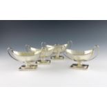 A set of four George III silver two-handled salt cellars, by John Robins, London 1800. oval form,