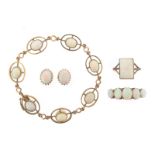 A gold bracelet mounted with oval-shaped cabochon opals, a pair of oval-shaped cabochon opal mounted