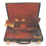 A gentleman's travelling part toilet set by Hermès Paris, the signed leather case 33cm wide and with