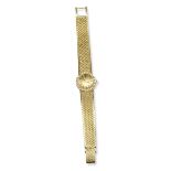 A lady's 18ct yellow gold wristwatch by Omega, the signed circular dial with diamond-set bezel and