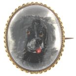 A late 19th century reverse-carved crystal brooch, depicting a dog within a gold mount. 3.5cm high.