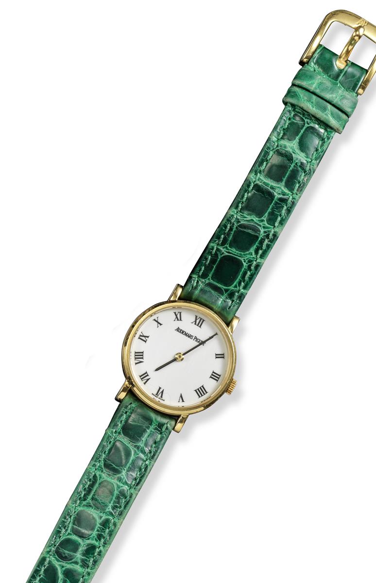 A lady's gold wristwatch by Audemars Piguet, the plain white dial with Roman numerals, 2.5cm wide (