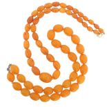 Two amber bead necklaces, both formed with oval-shaped beads. 27g, 50cm. 57g, 48cm.