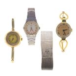 A lady's circular gold wrist watch by Gübelin, with an 18ct gold band. Another lady's gold
