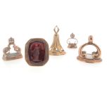 Five assorted 19th century gold and gold-cased fob seals, one mounted with a carnelian matrix