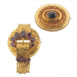 An oval-shaped Victorian gold locket brooch mounted with an oval-shaped garnet, and a Victorian gold