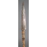 A Ron spear Bauchi Province, Nigeria with a stepped iron blade, with arch decoration on a hide bound