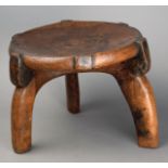 A Hehe stool Tanzania wood, with a circular top and three scroll legs, with pokerwork edge