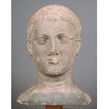 A Roman head of a youth 1st century BC / AD, stone, wearing a headband and with holes pierced