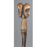 An Igkirra staff Kabba Province, Nigeria with a carved wood Janus double head finial, one with a