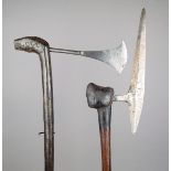 A Tsonga axe South Africa with a pointed iron vertical blade, on a wooden shaft with burnt