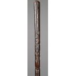 A Mexican cane wood, with carved geometric decoration and a spread eagle with serpent in its beak,