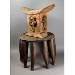 A Nupe stool Nigeria wood, with a carved top and nine legs, 38cm high, and a Bambara carved wood