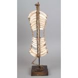 A Papua New Guinea chest ornament tusks, shells and fibre, 26cm high, on a stand. (2)