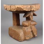 A Bambara stool Mali wood, the top decorated figures, a fish, a bird and a boat, on a carved