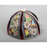 An Iroquois beadwork hat North America with six panels worked in Niagara floral style, 19cm