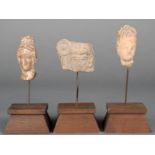 Three Hellenistic heads pottery, two females with their hair worn in a chignon, 5.5cm the highest,