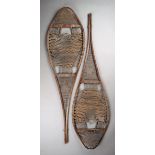 A pair of North American snow shoes bentwood, sinew and leather, 109cm long. (2)