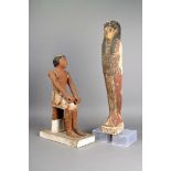 An Egyptian painted wood male figure Middle Kingdom, circa 2000 BC seated with jointed arms, with