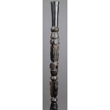 A Trobriand Islands staff Melanesia carved wood, with spiral serpents, rondels, scroll decorated