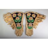 A pair of North American leather and beadwork gauntlets with floral panels, tassels and stitched