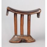 A Tsonga headrest Mozambique wood, with a curved top and tablet lifts with diced panels on triple