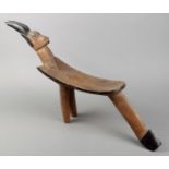 A Lobi stool Bukina Faso wood, with an antelope head surmount and on three legs, with blackened