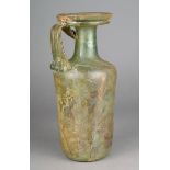 A Roman glass jug circa 2nd - 5th century AD green with a cylindrical body and tapering neck with