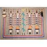 A Navajo Yei rug decorated with five figures with pray feathers and with a central maize plant, 99 x