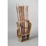 A Japanese quiver steam bent horn with apertures and including nine arrows with metal tips, reed,