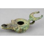 A Roman bronze oil lamp with a ring handle and crescent surmount, 12.6cm long.