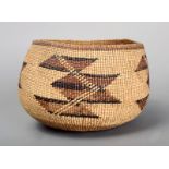 A Yurok basket North California of spherical form with four geometric panels, in shades of brown,