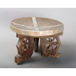 A Kamba stool Kenya wood, with applied aluminium bands and with pierced legs, 18cm high.