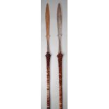 Two Naga spears Northern India wood, with shaped blades and wooden shafts, with hair decoration