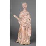 A Tanagra pottery figure of a lady circa 4th century BC hollow with a rectangular aperture to the